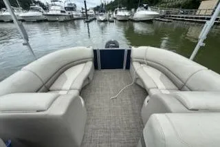Slide: The Image of 2023 Cypress Cay Seabreeze 232 pontoon boat with spacious seating in a marina. - 9
