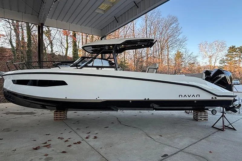 The Image of 2026 Navan S30 boat under shelter, sleek white design with black accents. - 2