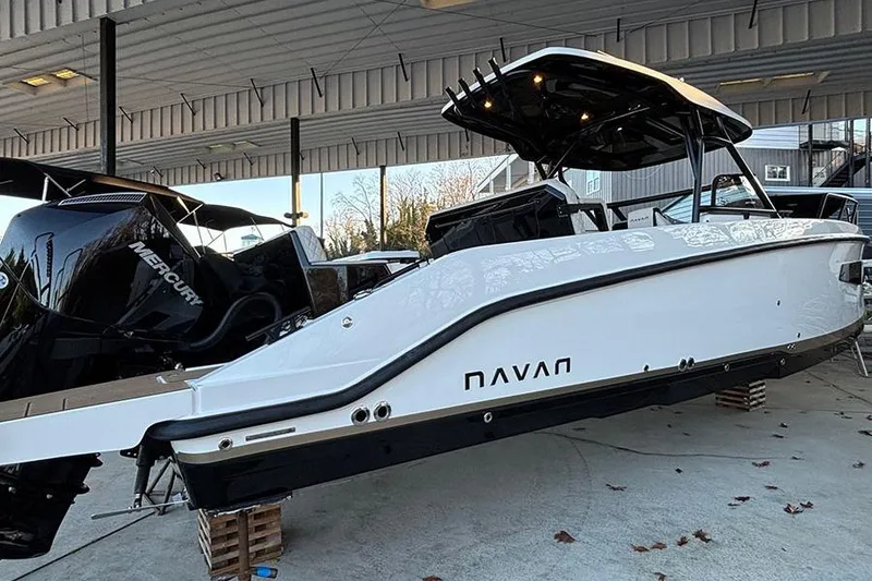 Slide: The Image of 2026 Navan S30 boat with Mercury engine, displayed in a covered marina setting. - 4