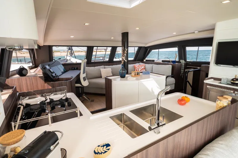 Slide: The Image of Luxurious 2026 Catana OC2 yacht interior with modern kitchen and spacious seating area. - 14