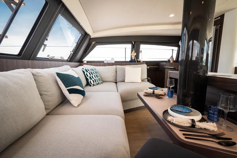 Slide: The Image of Luxurious interior of 2026 Catana OC2 yacht with modern seating and elegant dining setup. - 16