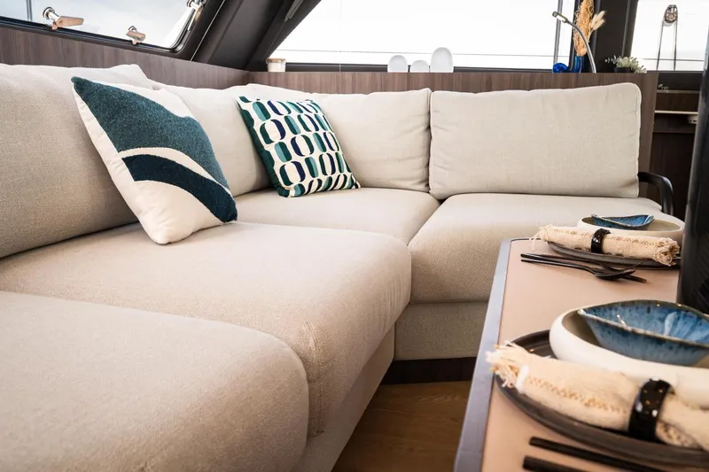 Slide: The Image of Luxurious interior of 2026 Catana OC2 yacht with elegant beige sofa and decorative pillows. - 17