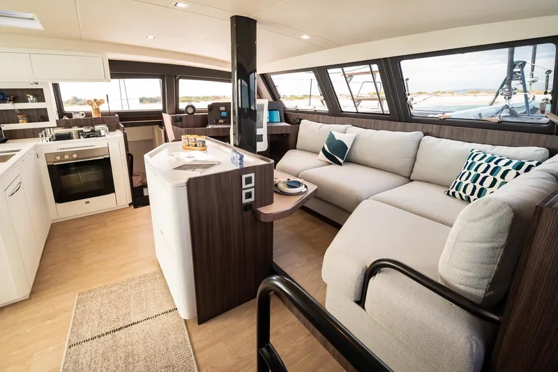 Slide: The Image of Luxurious interior of 2026 Catana OC2 yacht with modern kitchen and cozy seating area. - 18