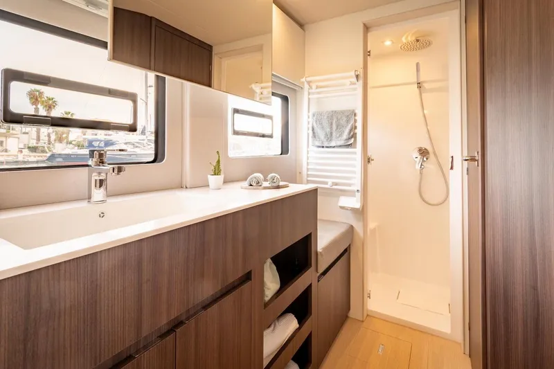 Slide: The Image of Modern bathroom interior in 2026 Catana OC2 yacht, featuring sleek wood cabinetry and spacious shower. - 22