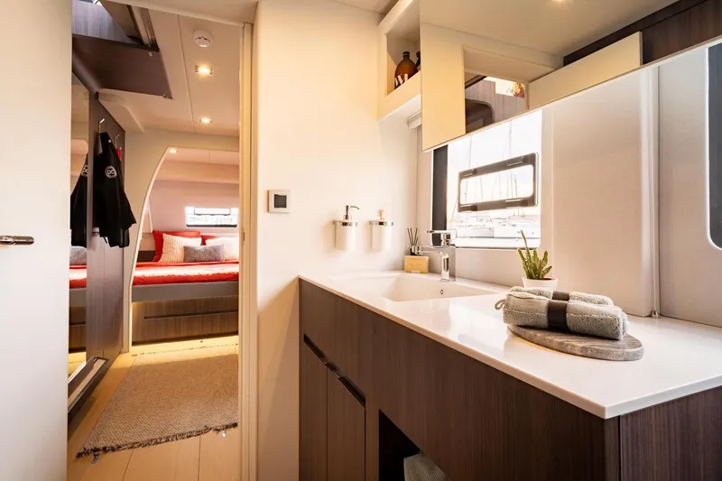 Slide: The Image of Luxurious interior of 2026 Catana OC2 yacht, featuring modern bathroom and cozy bedroom. - 23