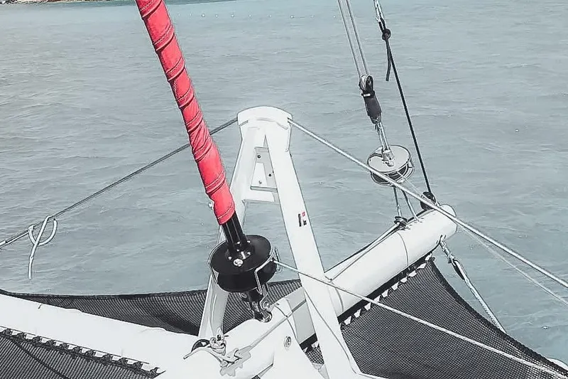 Slide: The Image of Catana OC2 2026 catamaran bow with rigging and netting over calm water. - 5