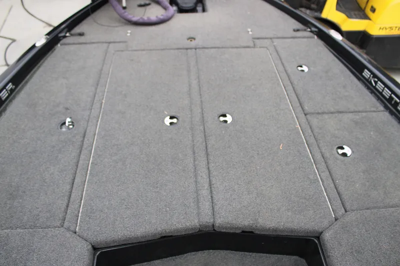 Slide: The Image of 2022 Skeeter ZX225 boat deck with carpeted storage compartments. - 14