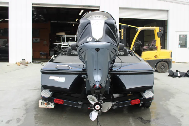 Slide: The Image of 2022 Skeeter ZX225 boat with outboard motor in a garage setting. - 17
