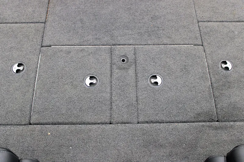 Slide: The Image of 2022 Skeeter ZX225 boat deck with gray carpet and storage compartments. - 19