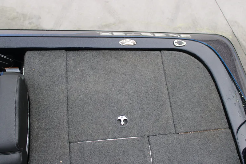 Slide: The Image of 2022 Skeeter ZX225 boat deck with carpeted surface and storage compartments. - 22