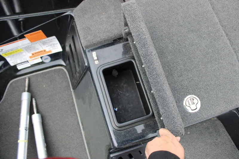 Slide: The Image of 2022 Skeeter ZX225 boat storage compartment with carpeted lid and hydraulic struts. - 5