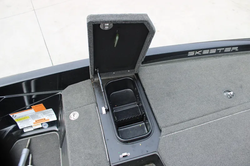 Slide: The Image of 2022 Skeeter ZX225 boat deck with open storage compartment and visible branding. - 6