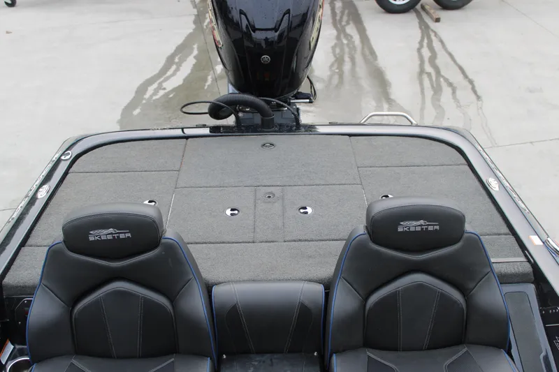 Slide: The Image of 2022 Skeeter ZX225 boat interior with dual seats and carpeted deck. - 8