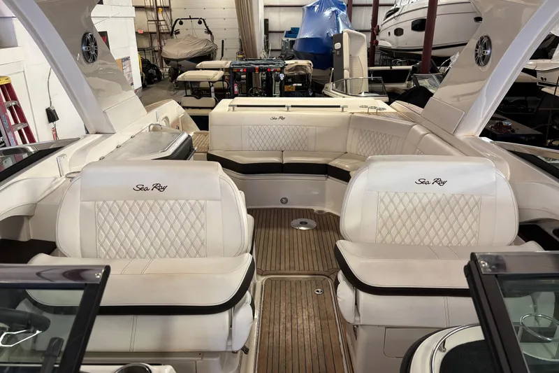 Slide: The Image of 2023 Sea Ray SLX 310 boat interior with luxurious seating and wood flooring. - 12