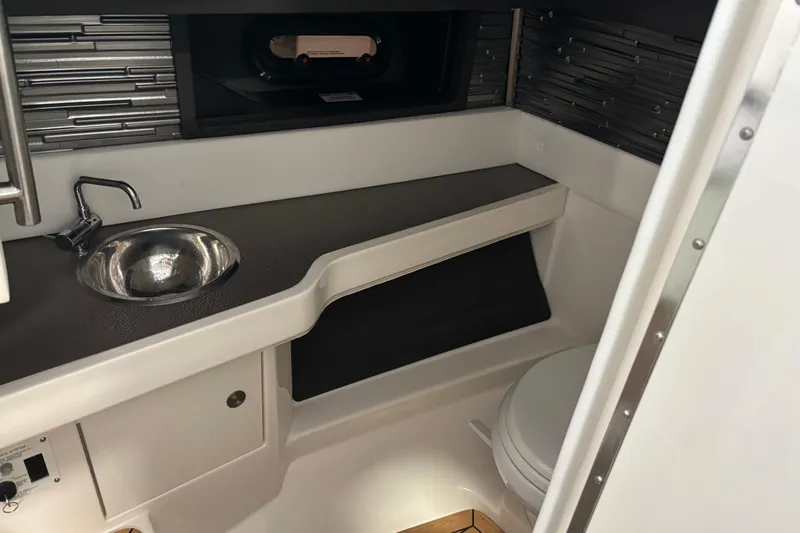 Slide: The Image of 2023 Sea Ray SLX 310 boat interior with sink and toilet. - 13