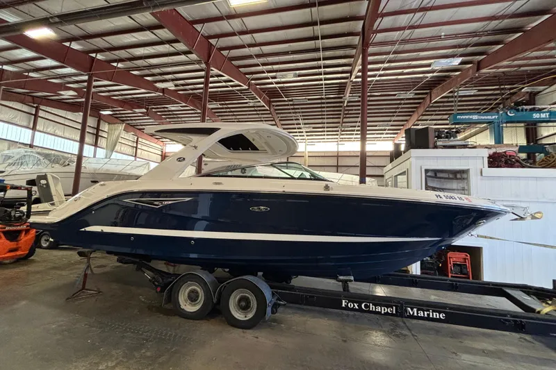 Slide: The Image of 2023 Sea Ray SLX 310 boat in a marina warehouse setting. - 3