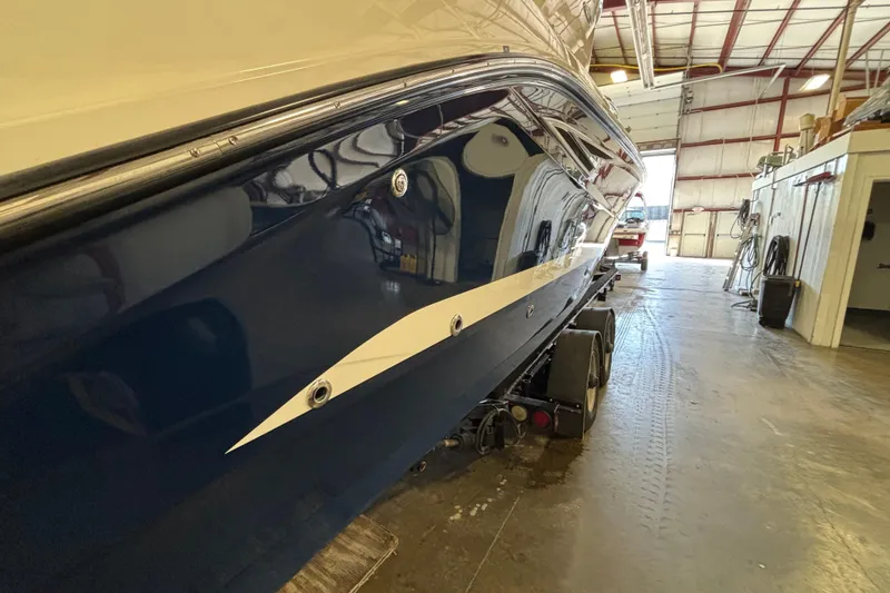 Slide: The Image of 2023 Sea Ray SLX 310 boat in a warehouse, side view on trailer. - 5