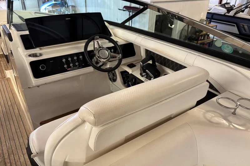 Slide: The Image of 2023 Sea Ray SLX 310 helm with modern controls and luxurious seating. - 8
