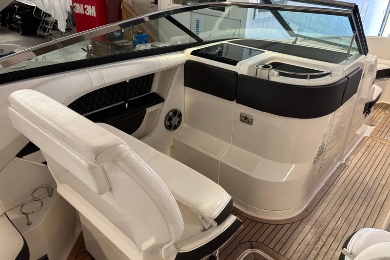 Slide: The Image of 2023 Sea Ray SLX 310 boat interior with white seating and sleek design. - 9