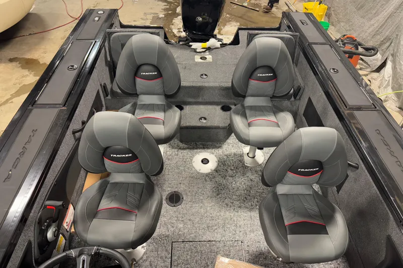 Slide: The Image of 2026 Tracker Targa V-18 Combo boat interior with four gray seats. - 11