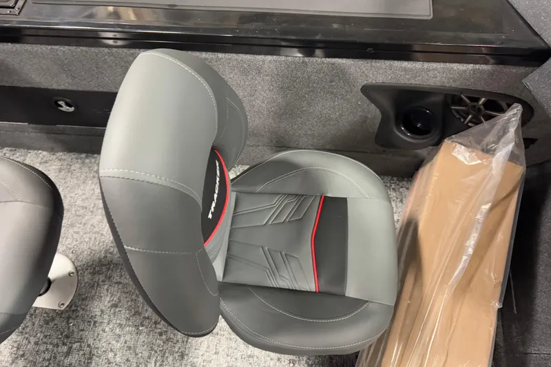 Slide: The Image of 2026 Tracker Targa V-18 Combo boat seat with gray upholstery and red accents. - 12