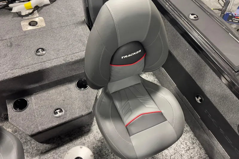 Slide: The Image of 2026 Tracker Targa V-18 Combo boat seat with gray upholstery and red accents. - 13