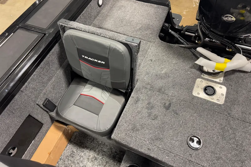 Slide: The Image of 2026 Tracker Targa V-18 Combo boat interior with gray seating and carpeted flooring. - 15