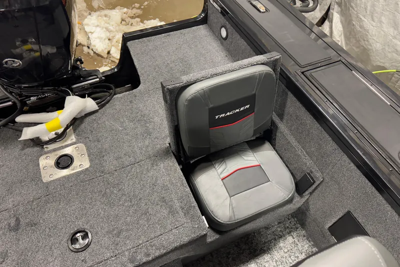 Slide: The Image of 2026 Tracker Targa V-18 Combo boat interior with gray seating and carpeted flooring. - 16