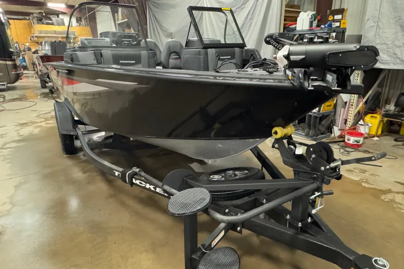 Slide: The Image of 2026 Tracker Targa V-18 Combo boat on trailer in indoor storage facility. - 2