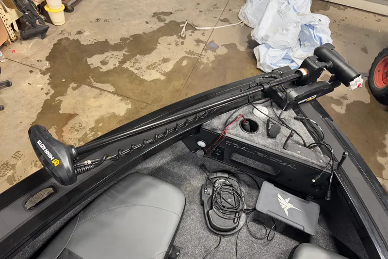 Slide: The Image of 2026 Tracker Targa V-18 Combo boat with Minn Kota trolling motor in a garage setting. - 22