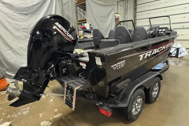 Slide: The Image of 2026 Tracker Targa V-18 Combo boat with Mercury engine in a garage setting. - 3