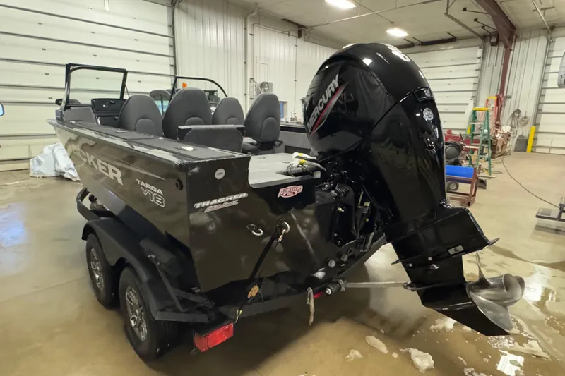 Slide: The Image of 2026 Tracker Targa V-18 Combo boat with Mercury outboard motor in a garage. - 4