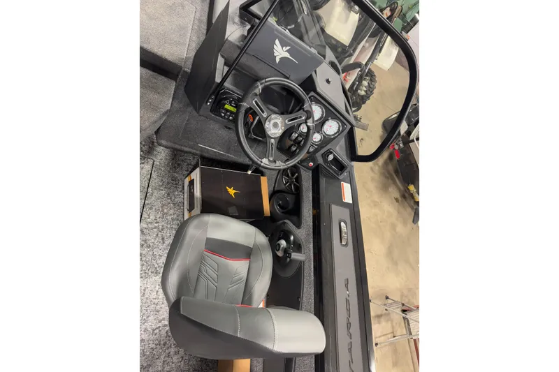 Slide: The Image of 2026 Tracker Targa V-18 Combo boat interior with steering wheel and dashboard controls. - 8