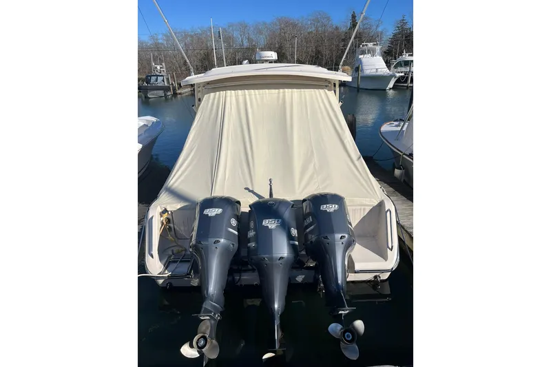 The Image of 2015 Grady-White Freedom 375 boat with triple Yamaha 350 engines docked at marina. - 0