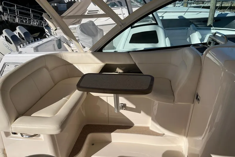 Slide: The Image of 2015 Grady-White Freedom 375 boat interior with beige seating and table. - 10