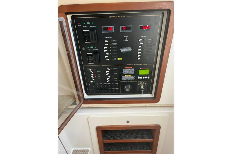 Slide: The Image of Control panel of a 2015 Grady-White Freedom 375 boat, featuring various switches and displays. - 19
