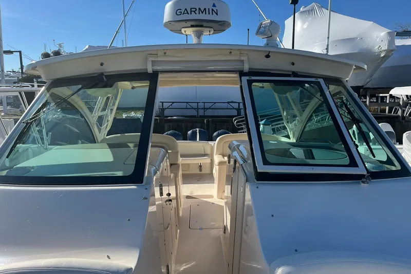 Slide: The Image of 2015 Grady-White Freedom 375 boat with Garmin radar, docked under clear skies. - 2