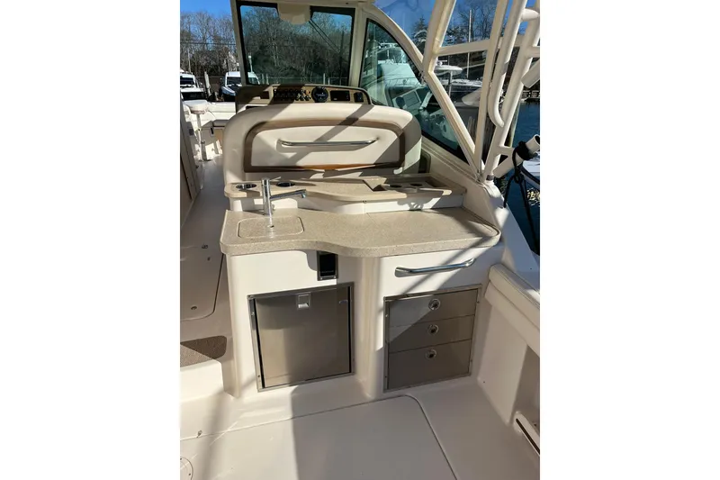 Slide: The Image of 2015 Grady-White Freedom 375 boat interior with sink and storage drawers. - 7