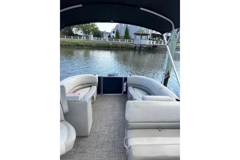 Slide: The Image of 2023 Cypress Cay Seabreeze 232 pontoon boat interior with plush seating and scenic water view. - 7