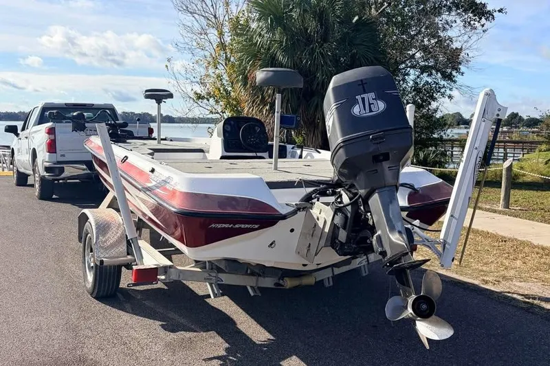 Slide: The Image of 1998 Hydra-Sports 185 boat on trailer, parked near a lake with a pickup truck. - 5