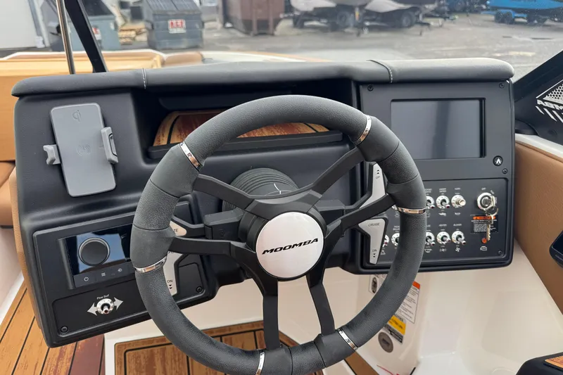 Slide: The Image of 2026 Moomba Mondo boat dashboard with steering wheel and control panel. - 10