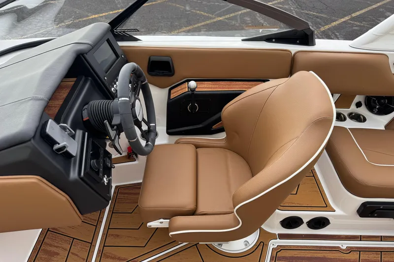 Slide: The Image of 2026 Moomba Mondo boat interior with tan leather seating and modern dashboard. - 11