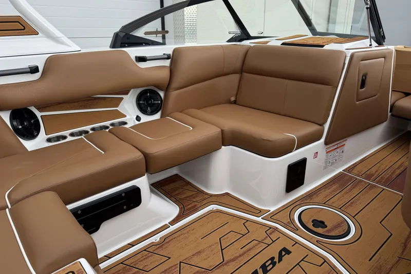 Slide: The Image of 2026 Moomba Mondo boat interior with brown leather seating and wood-style flooring. - 12