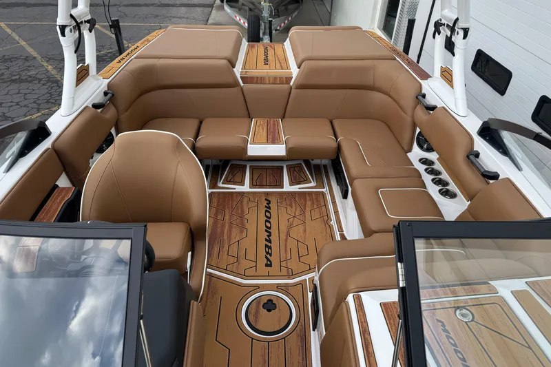 Slide: The Image of 2026 Moomba Mondo boat interior with tan seating and wood accents. - 9