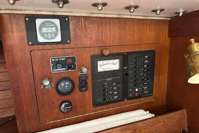 Slide: The Image of Control panel of a 1987 J Boats J28 sailboat, featuring gauges and switches. - 13