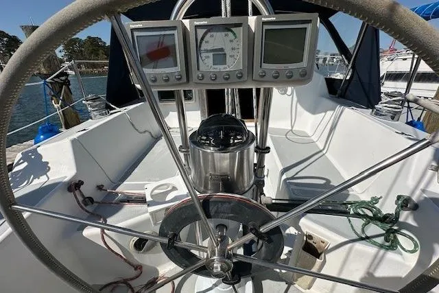 Slide: The Image of 1987 J Boats J28 sailboat cockpit with steering wheel and navigation instruments. - 18