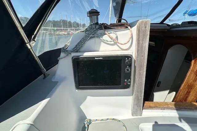 Slide: The Image of 1987 J Boats J28 cockpit with navigation equipment and ropes. - 19