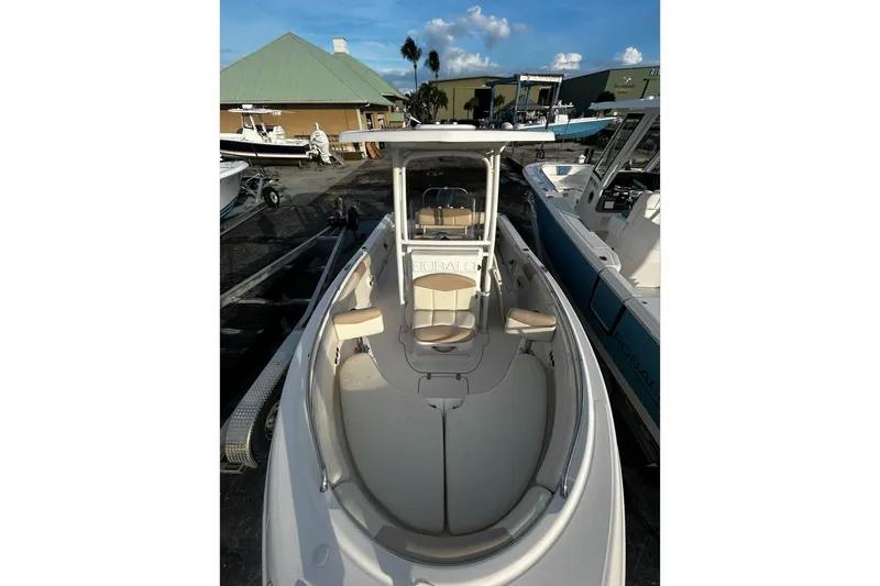 Slide: The Image of 2016 Robalo R222 Center Console boat in a marina, featuring spacious seating and sleek design. - 3