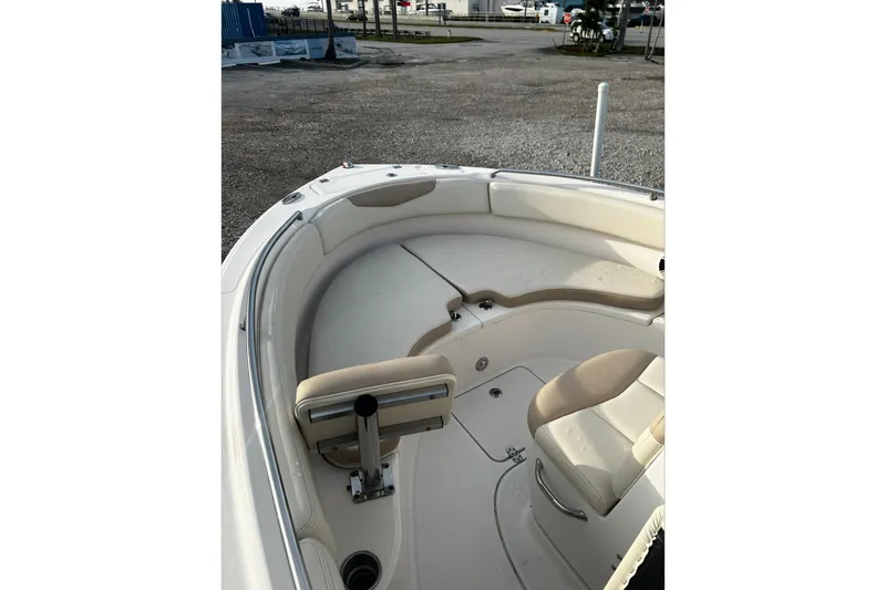 Slide: The Image of 2016 Robalo R222 Center Console boat interior with cushioned seating and storage compartments. - 4