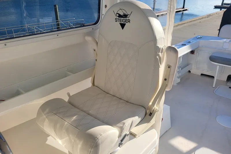 Slide: The Image of 2021 Steiger Craft 255 DV MIAMI boat interior with white cushioned seating. - 14